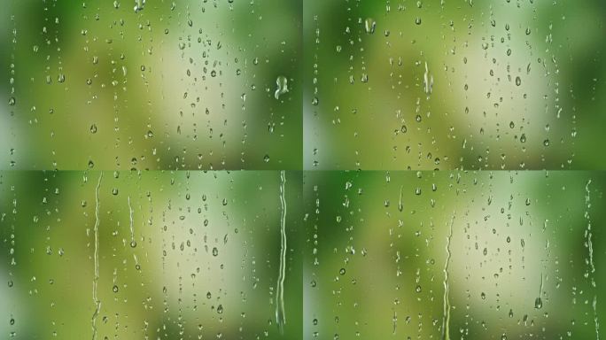 雨滴在绿色的背景下滑下窗户