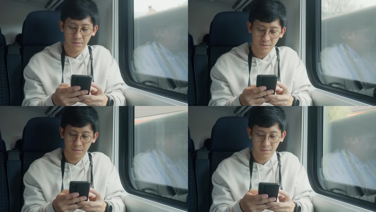 亚洲男子乘火车旅行时用智能手机查看地图。