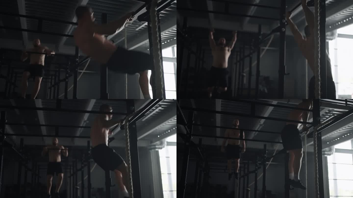 运动员在健身房训练，英俊的肌肉男裸体上身在横梁上做引体向上