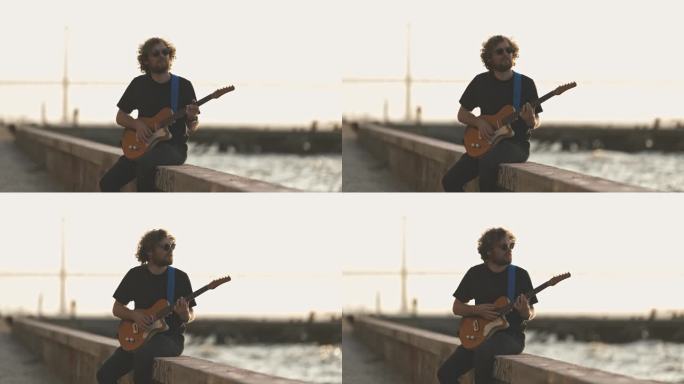 一个人坐在海边，在日落时分弹吉他
