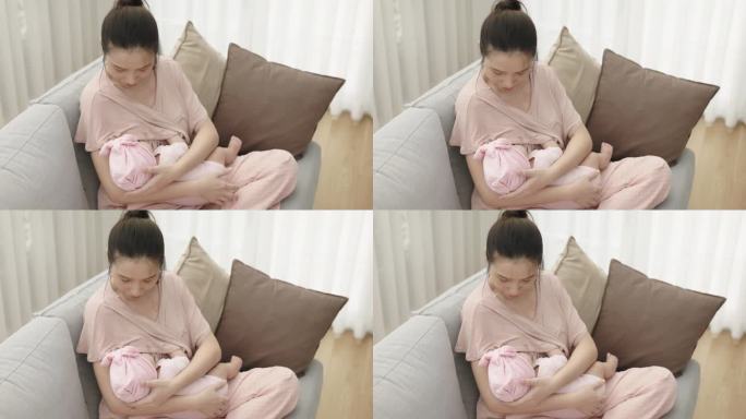 亚洲新生儿在家喝妈妈的奶。照顾幼儿的健康。饥饿时母乳喂养