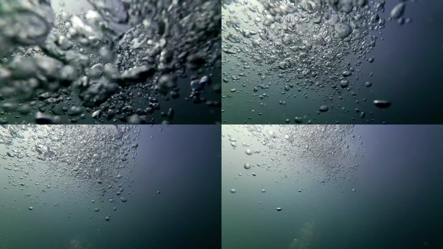 电影水下拍摄的气泡在黑暗的水域中慢动作