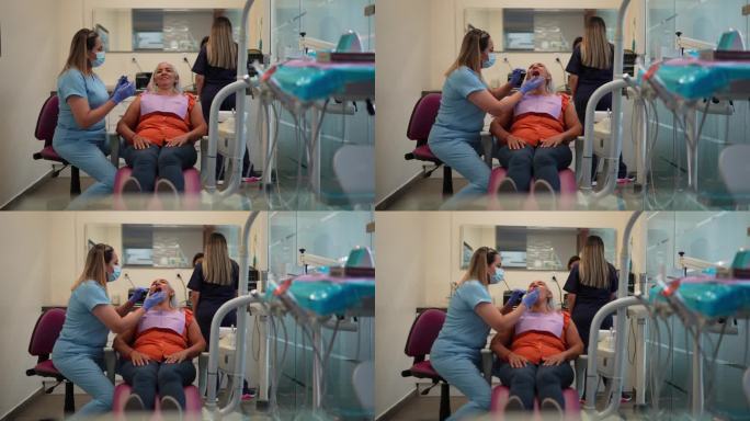 在诊所接受牙医牙齿检查的成熟妇女