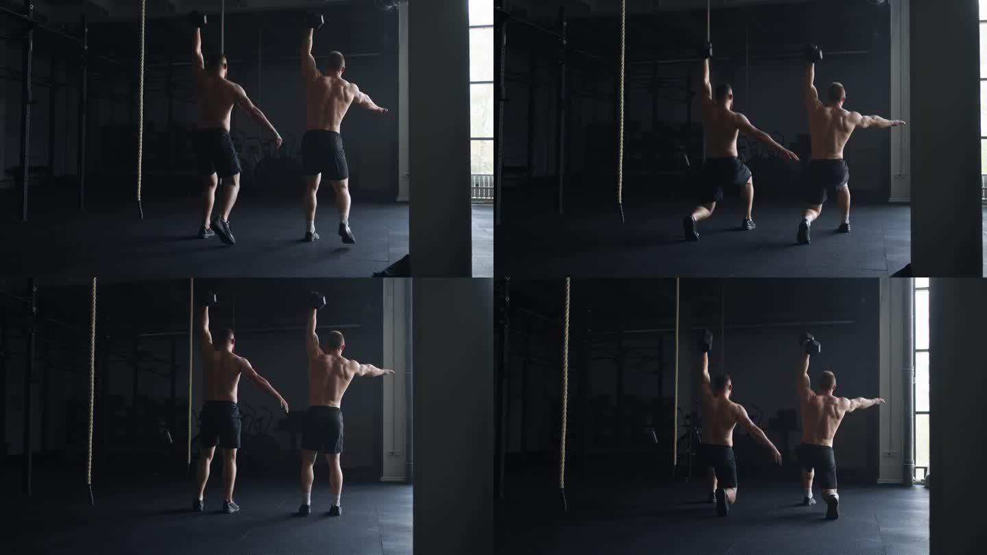 一对运动员裸露的肌肉躯干在健身房做练习，下蹲拿哑铃