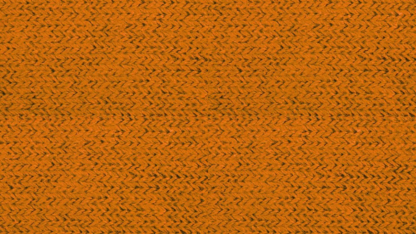 橙色纹理织物布料特写，纺织品背景。从左到右的运动。