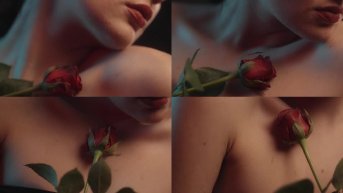 性感的女人用红色的口红和纹身黑色背景工作室拍摄跳舞与一个单一的红玫瑰和压花瓣对皮肤