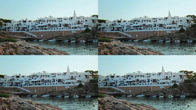比尼贝卡湾(Binibeca well)海边的船只，背景是4K的城镇景色。