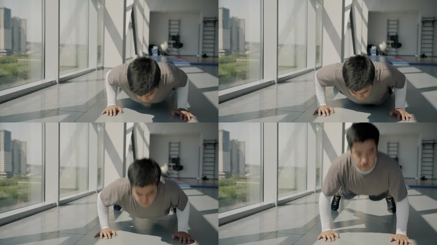 动感十足的亚洲运动员在现代体育馆里独自做俯卧撑训练的慢镜头