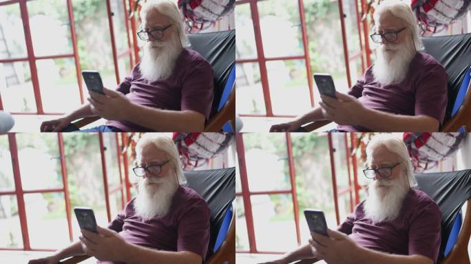 老人在家使用手机外国人老年人看手机特写视