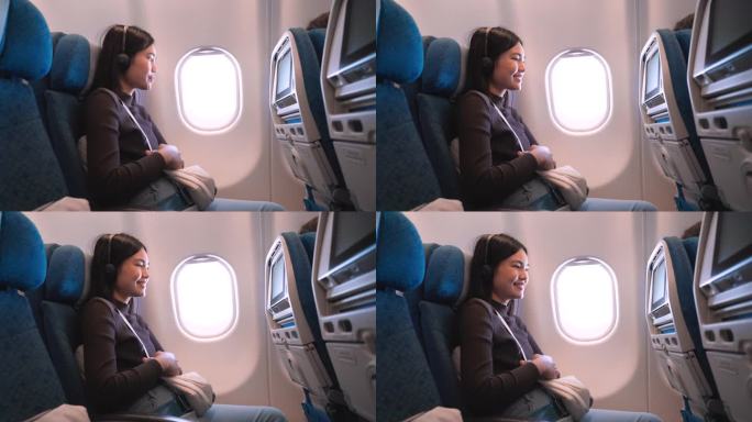机上娱乐:她在一架商用飞机的经济舱座位上轻敲屏幕。