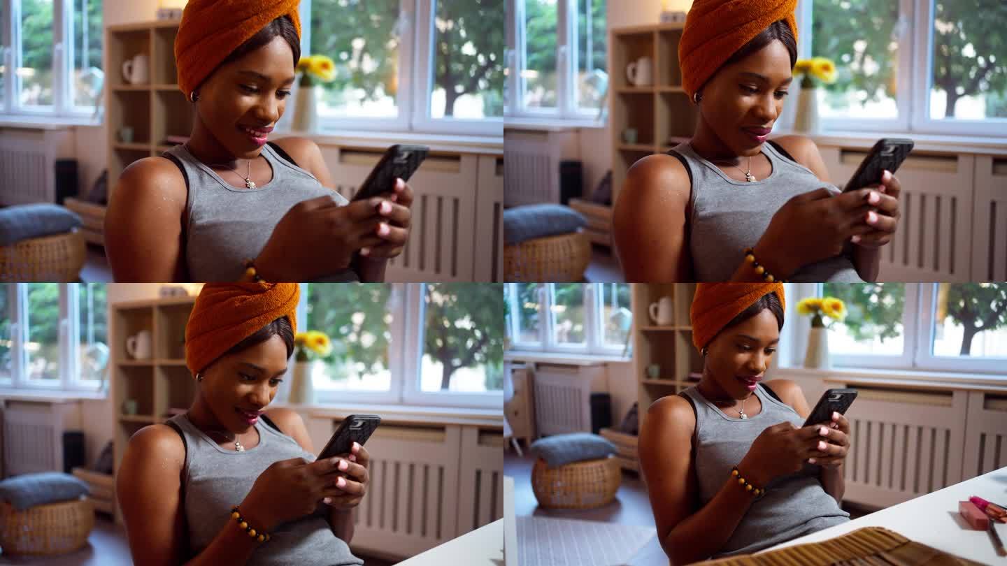一名黑人妇女在化妆时使用手机