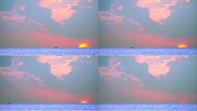 夕阳在海上与渔船和红橙黄云的背景时间流逝