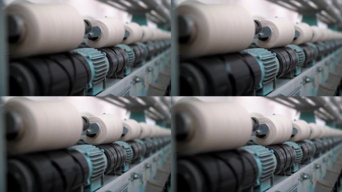 纺织厂设备。线生产。纺织工厂。纺纱生产。纱线制作工艺。近距离的纱线线轴。
