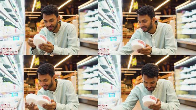 印度男子在杂货店买奶制品。帅哥买冰淇淋的侧视图