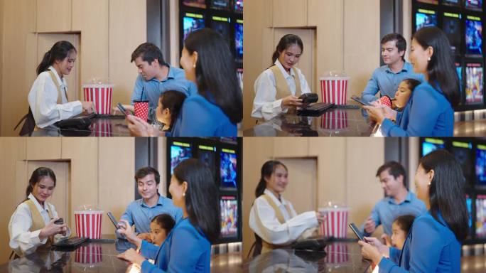 快乐的亚洲家庭在电影院售票处选择座位和购买电影票。母亲在电影院售票处购买电影票时使用智能手机扫描支付