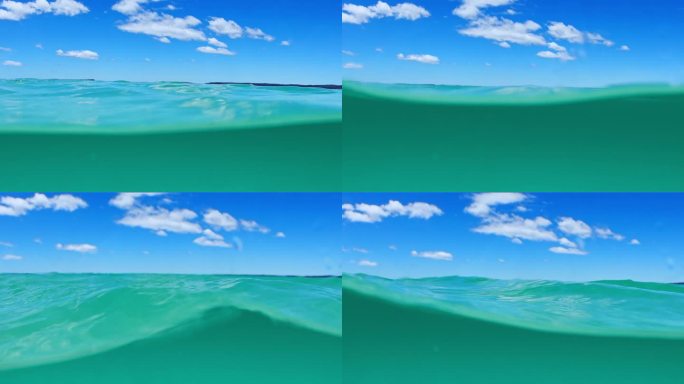 干净，清澈的海水分割镜头显示水面下和蓝天之上