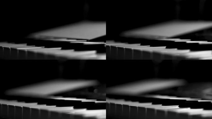 特写宏观的黑色和白色钢琴键。优雅的钢琴琴键移动，近距离。跟踪向后投篮。缓慢的运动。黑白键。钢琴琴键上