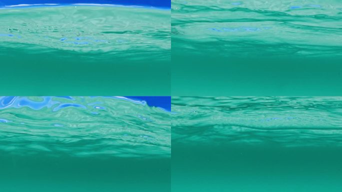 干净，清澈的海水分割镜头显示水面下和蓝天之上