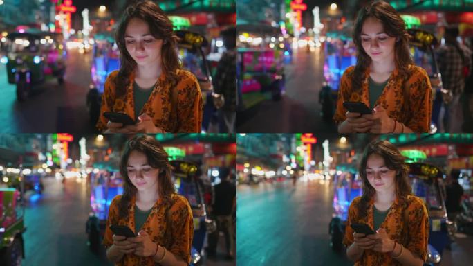 手持智能手机的女子站在曼谷唐人街