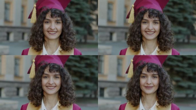 雄心勃勃的女士戴着毕业帽站在户外微笑着享受硕士学位的慢动作肖像