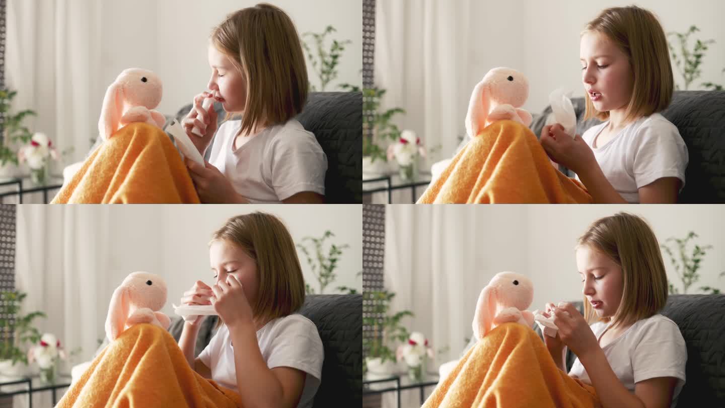 可爱的小女孩用冷喷雾剂擤鼻涕