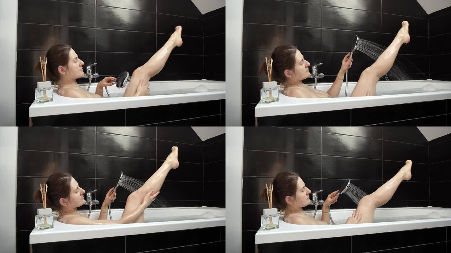 一位女性享受水疗般的体验，放松地泡个澡，在温和的淋浴下小心地洗腿——自我护理和放松。