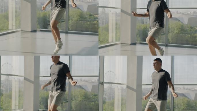 倾斜的肖像肌肉发达的年轻人训练跳绳在美丽的阳光健身房