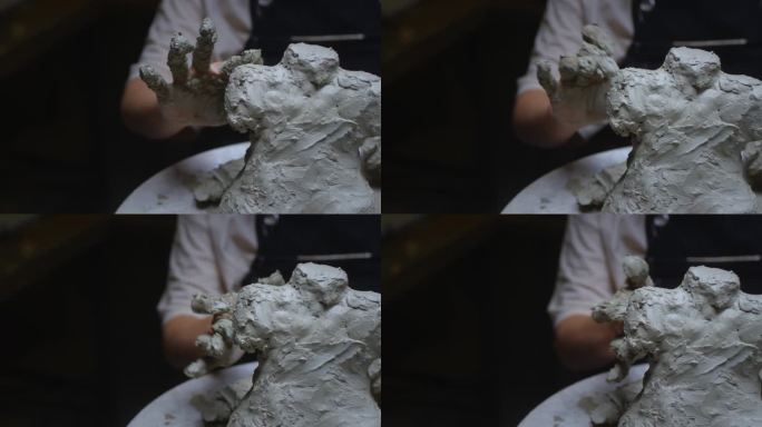 一个年轻的陶艺女孩在工作室的车间里用她的双手制作雕塑。粘土制成的女性雕像。女人完美的古色古香的身材。