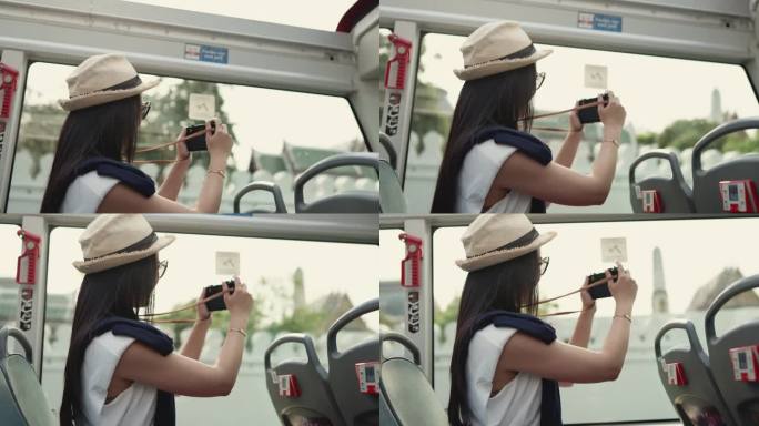 美丽的女人用相机捕捉城市旅游巴士上的景色