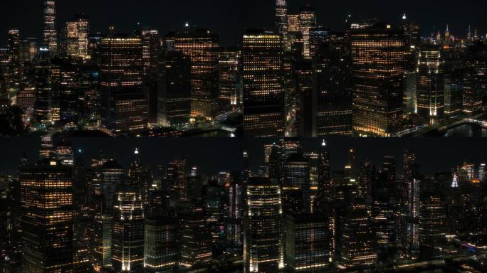 华尔街办公大楼夜景:纽约曼哈顿下城建筑的空中风景。全景金融区镜头从直升机。纽约的夜景