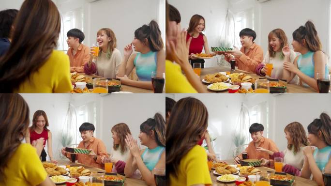 一群亚洲年轻人在家里聚餐。