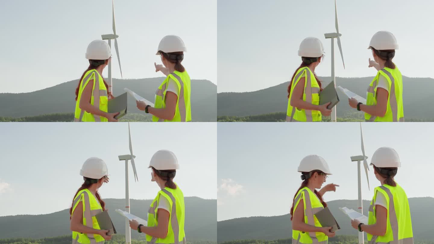 女性工程团队证实了风能作为一种环保能源的重要性。妇女们戴着头盔，戴着眼镜，手里拿着敲灯的信号胶，手里
