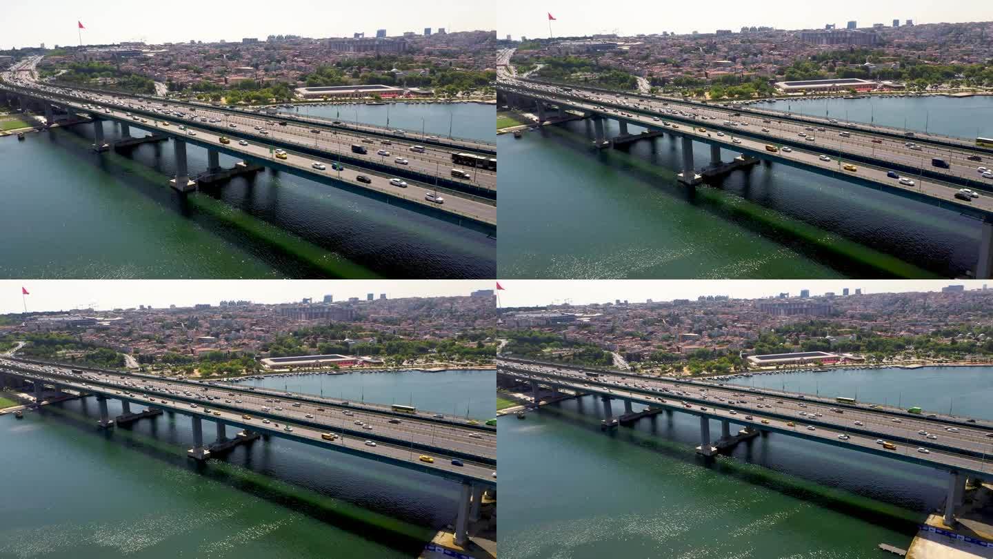 伊斯坦布尔金角的4K航拍画面。无人机在白天从海上的桥上放大。