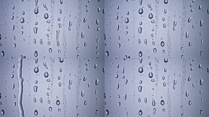 雨点从窗户滑下雨滴滑落特写