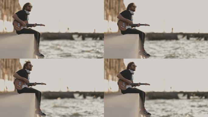 一个人坐在海边弹吉他