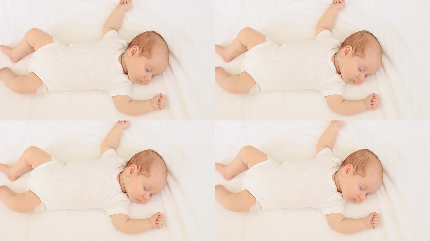 一个刚出生的婴儿穿着白色的紧身衣睡在家里的棉床上，特写肖像，文字空间