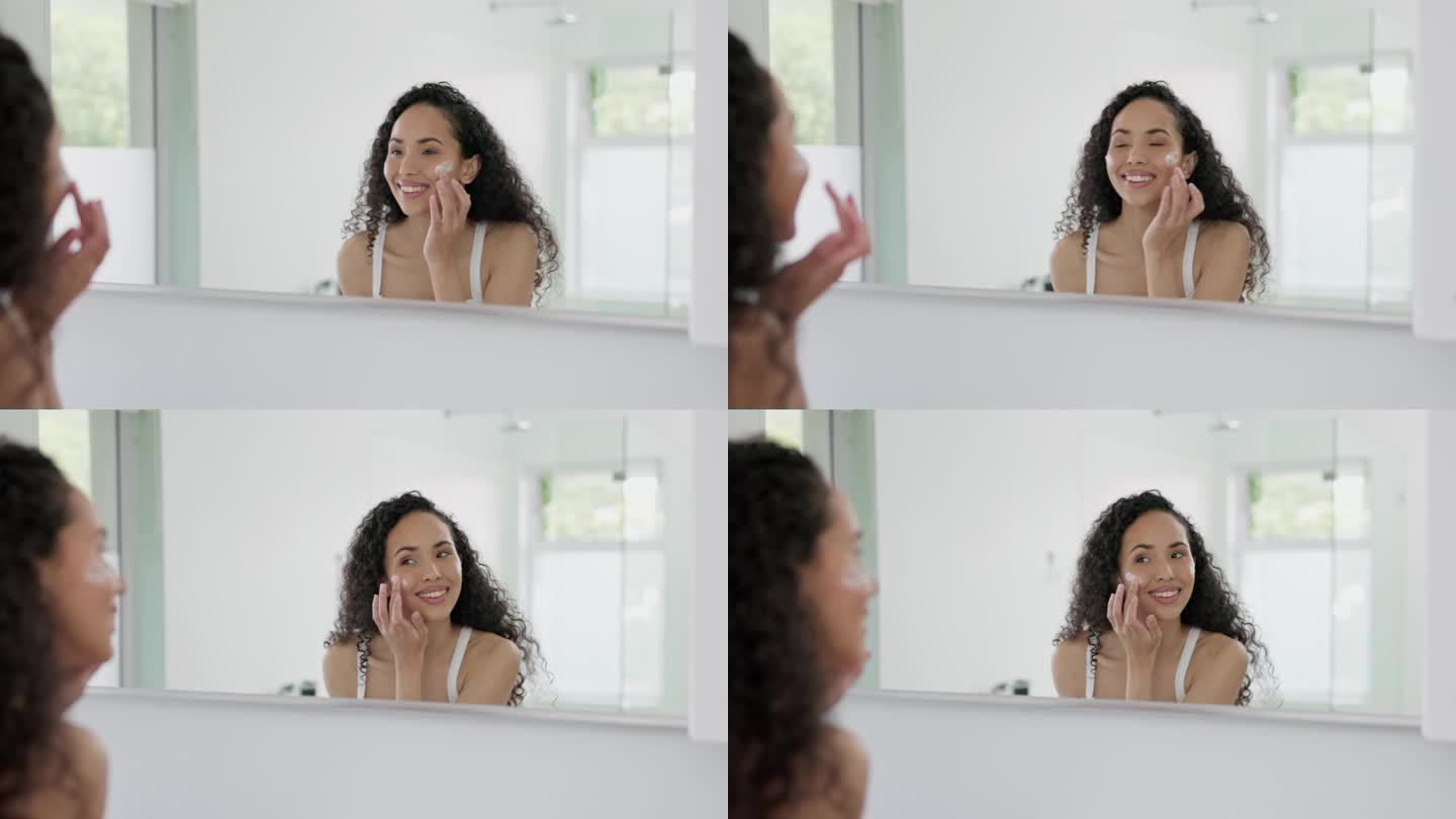 快乐的女人，面霜照镜子，在家里的浴室里做护肤、美容化妆品或健康保健。美丽的女性微笑着使用面霜、乳液或