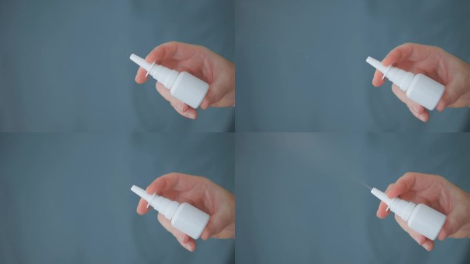 白色的瓶子和鼻喷雾剂在一个统一的背景上。喷药。