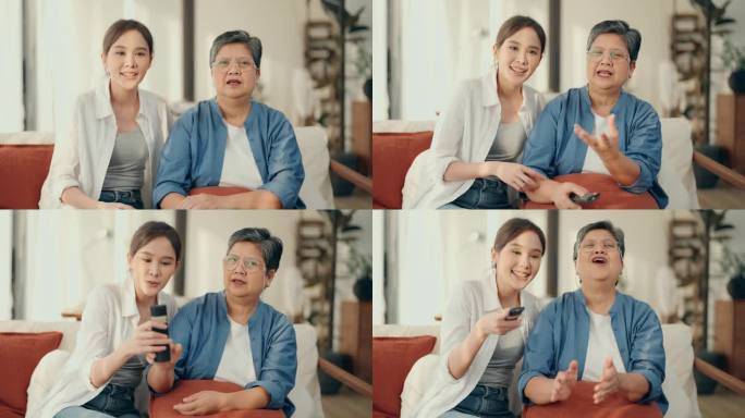 亲密的关系:亚洲老年妇女和女儿全神贯注于电视节目，分享笑声和积极的情绪在家里