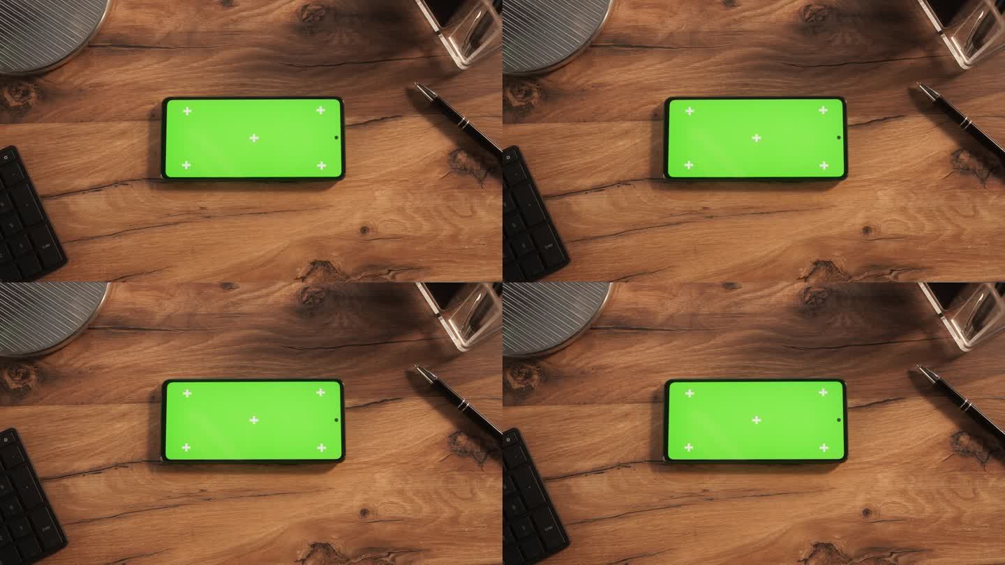 一个智能手机与模拟绿色屏幕Chromakey显示与运动跟踪占位符的自上而下的视图。一个手机设备水平躺