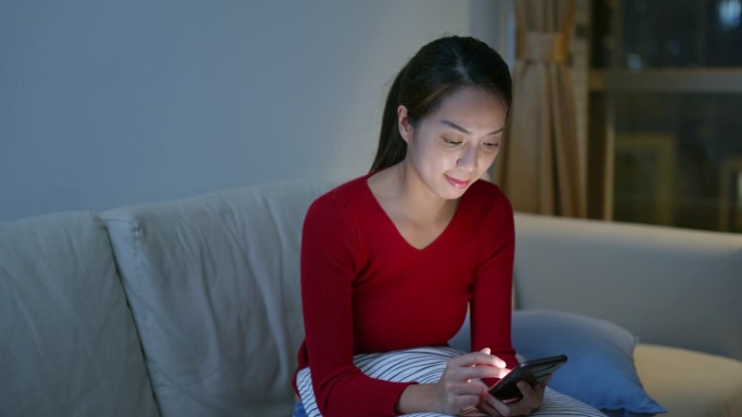 女人在晚上使用手机