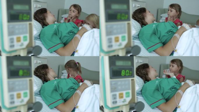 两个小女孩去医院看望妈妈。躺在医院病房病床上接受输液治疗的年轻女病人。
