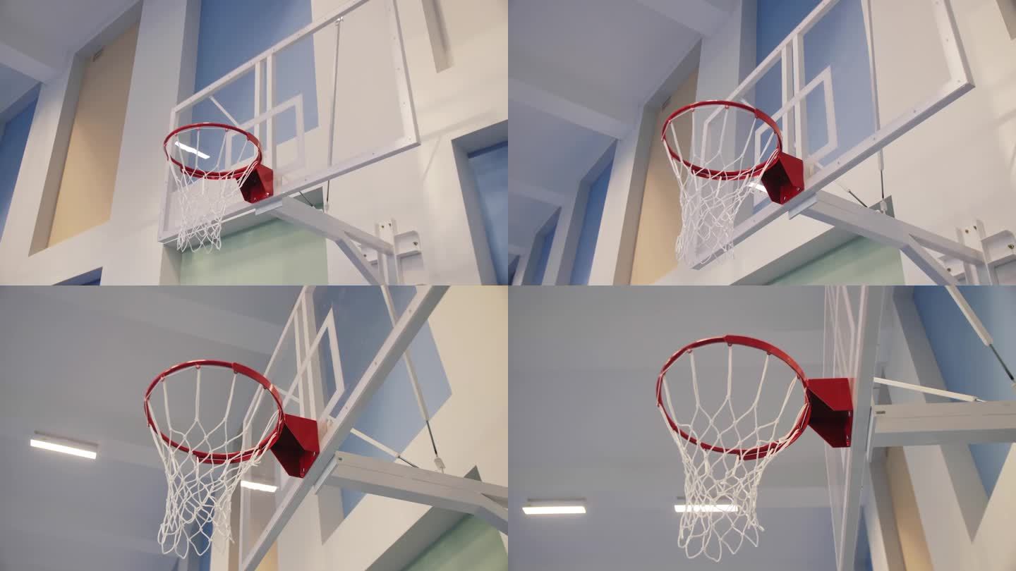 体育馆的透明塑料防护罩上带网的篮筐
