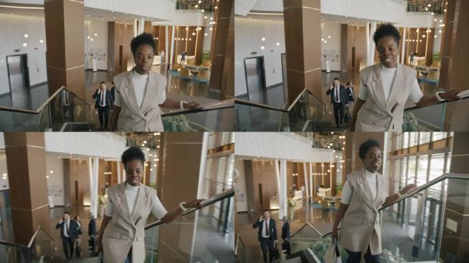 一幅愉快的年轻非裔美国女商人在酒店上楼的肖像