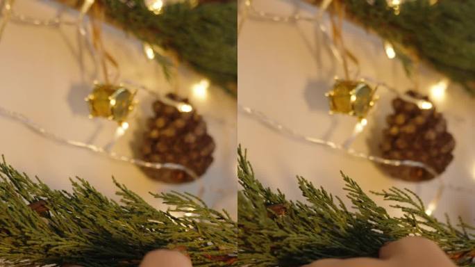 垂直视频。为圣诞节手工制作墙壁装饰，用树枝制作一棵带有花环和装饰品的迷你树