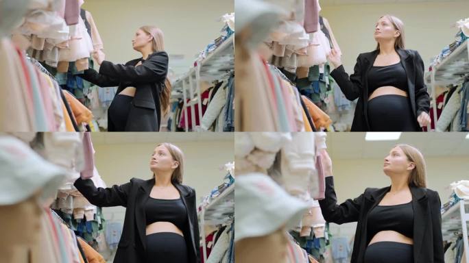 怀孕的顾客分析衣架上的流行服装，未来的妈妈想买打折的衣服