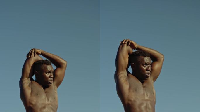 一个强壮的非洲男人在阳光明媚的日子里在户外伸懒腰
