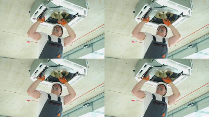 安装或修理吊顶空调机组的工人