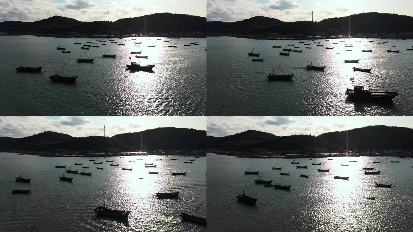 蓬莱长岛海岛渔船停泊在海上剪影4K航拍