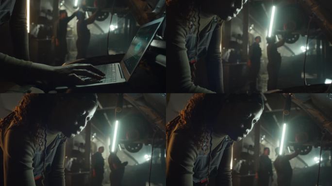 女汽车修理工在工作中使用笔记本电脑